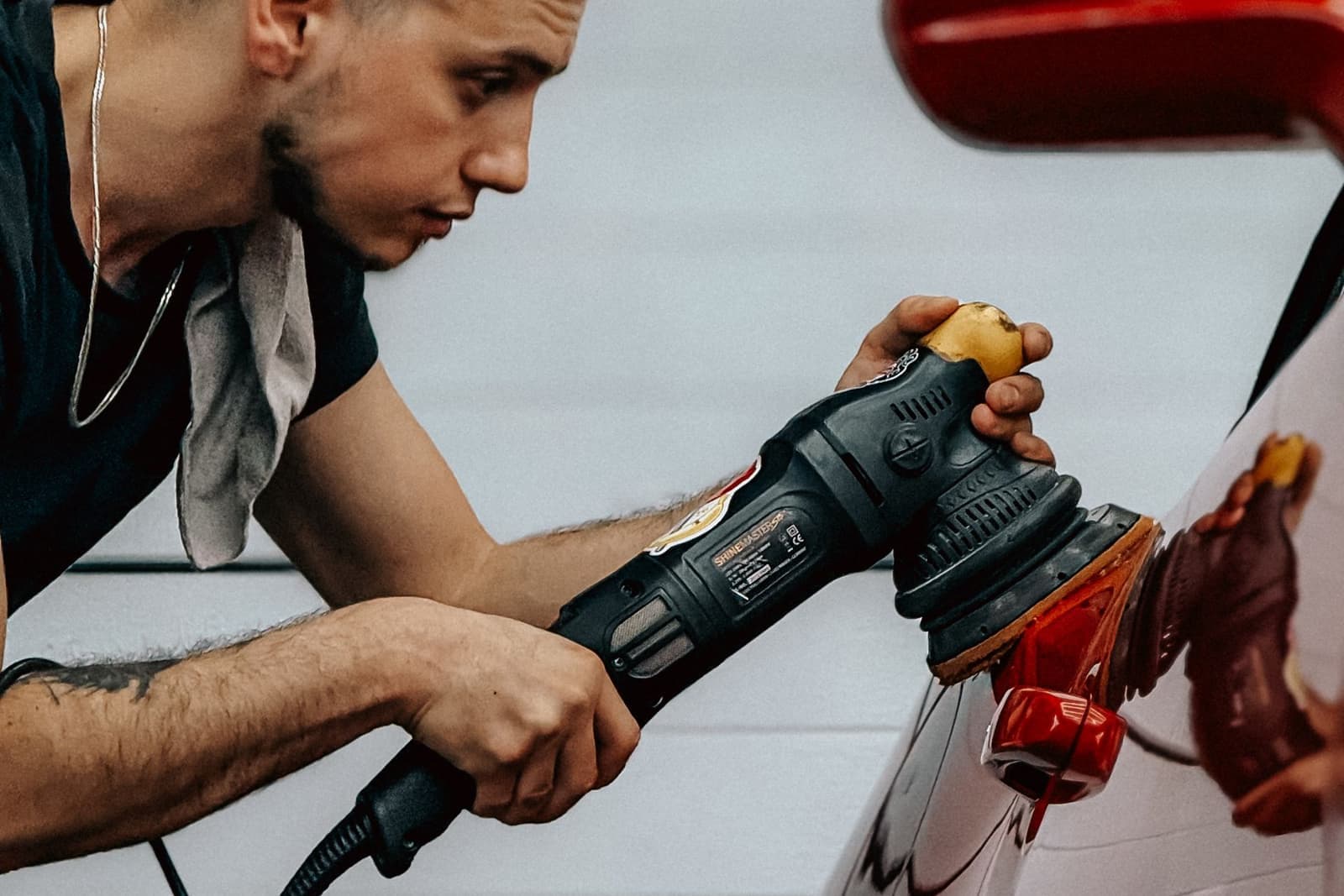 Detailer polishing a car